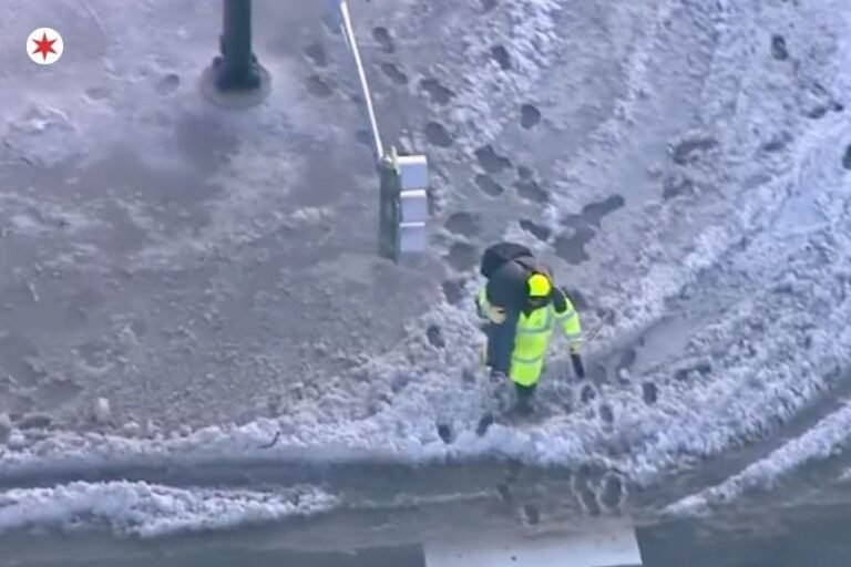 HERO Crossing Guard Carries A Child on His Back Across a flooded Chicago Street During Freezing Morning.