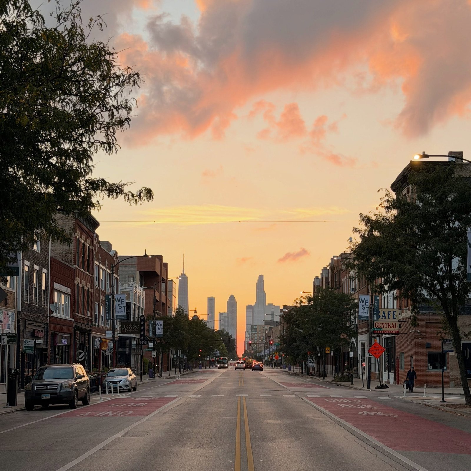 Vibrant street scene in a trendy Chicago neighborhood featuring colorful murals, historic brick architecture, and lively sidewalk cafes.