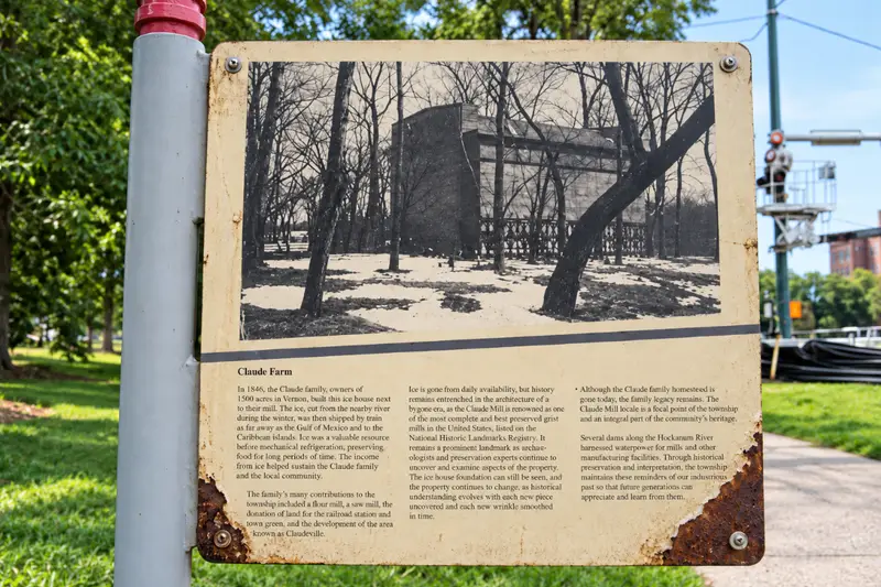 A rusted, weathered historical marker in Lincoln Park featuring a black-and-white archival photo of the Couch Tomb and faded text explaining its history.