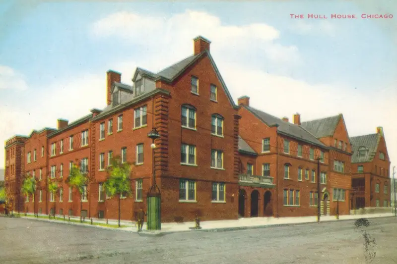 A vintage early 20th-century postcard showing the sprawling red-brick exterior of the Hull-House settlement complex in Chicago, the historic site of the 1913 Devil Baby mass hysteria.